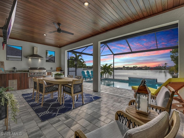 sunroom / solarium with a water view, ceiling fan, and wooden ceiling