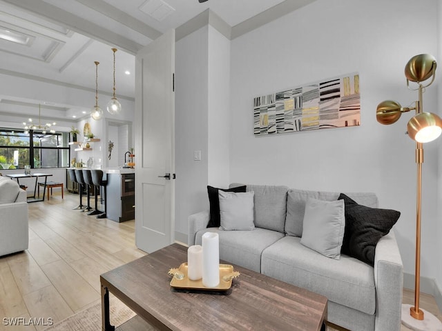 living room featuring an inviting chandelier and light hardwood / wood-style flooring