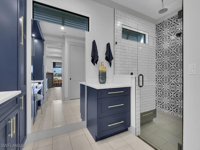 bathroom with vanity, tile patterned floors, and a shower with shower door