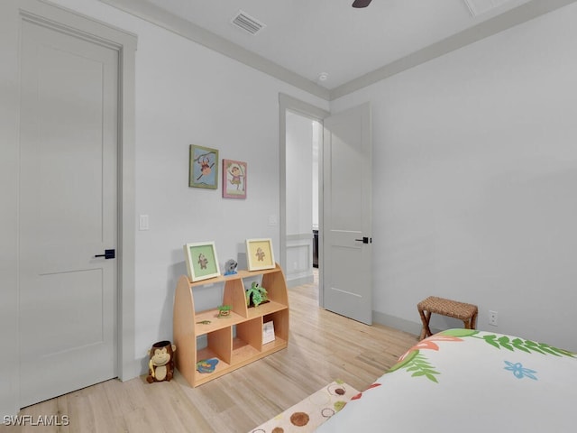 bedroom with light hardwood / wood-style flooring and ceiling fan