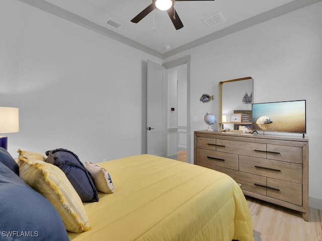 bedroom with light hardwood / wood-style floors and ceiling fan