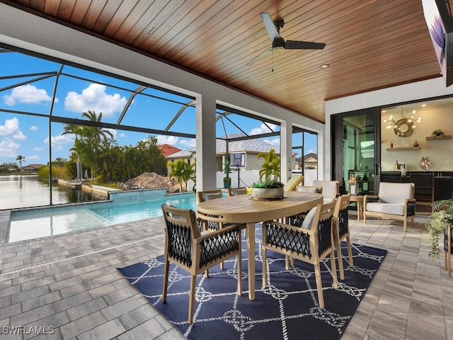 sunroom with wood ceiling, ceiling fan, and a water view