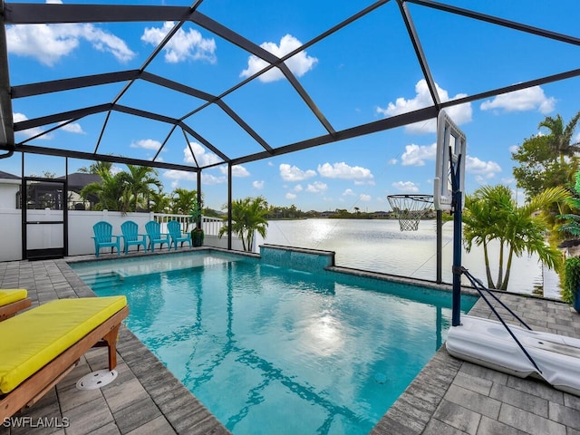 view of pool with a water view, glass enclosure, and a patio area