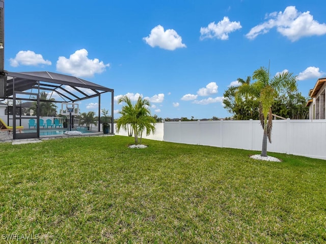 view of yard with a fenced in pool and a lanai