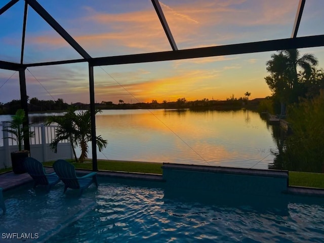 pool at dusk with a water view and glass enclosure