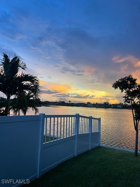 exterior space featuring a water view and a lawn