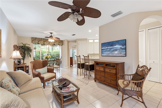 living room with ceiling fan and light tile patterned floors