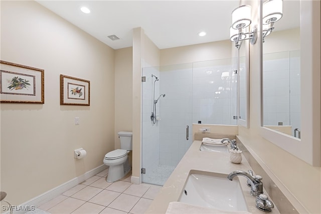 bathroom with toilet, vanity, a shower with door, and tile patterned floors