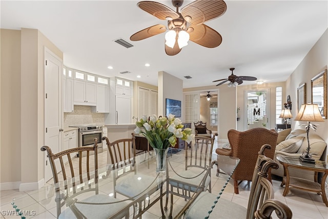 tiled dining room featuring ceiling fan