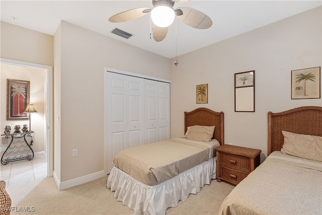 bedroom featuring ceiling fan, a closet, and light carpet