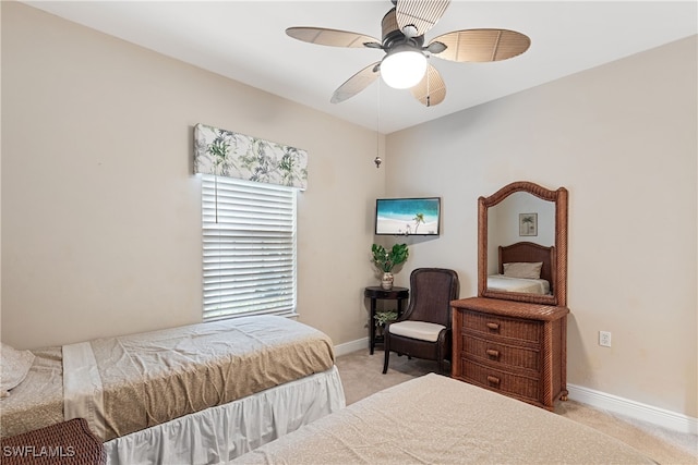 bedroom featuring ceiling fan and light carpet