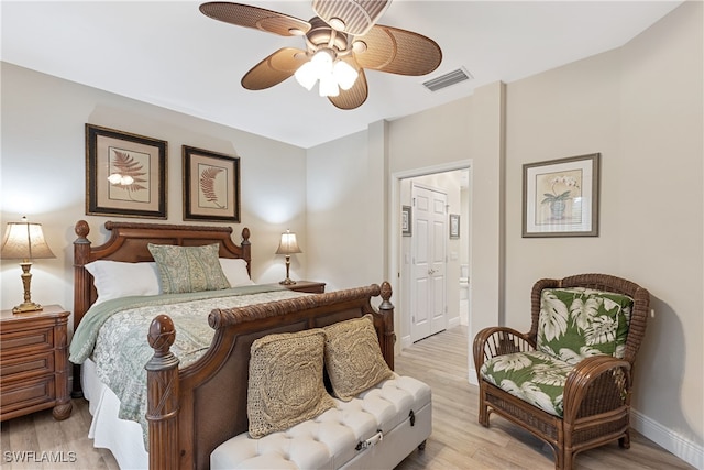 bedroom with ensuite bathroom, ceiling fan, and light hardwood / wood-style flooring