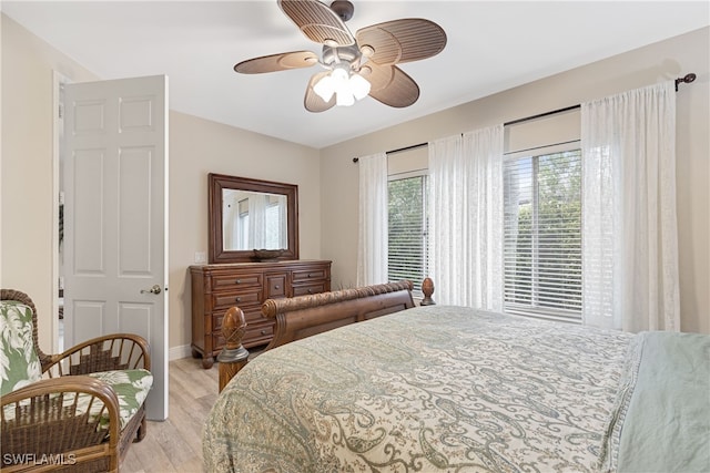 bedroom with ceiling fan and light hardwood / wood-style flooring