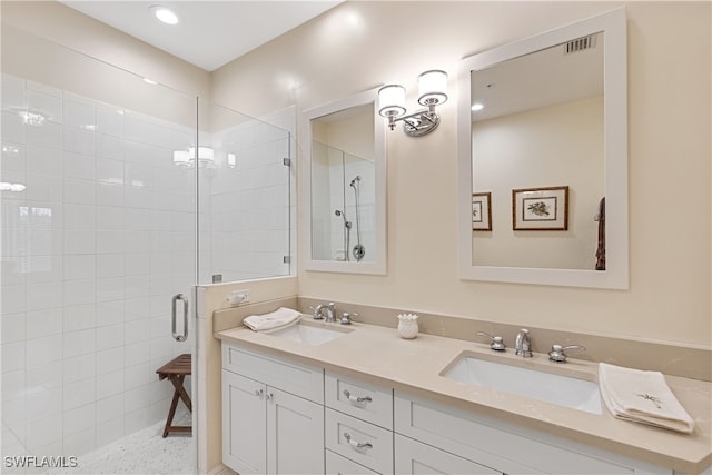 bathroom with a shower with shower door and vanity