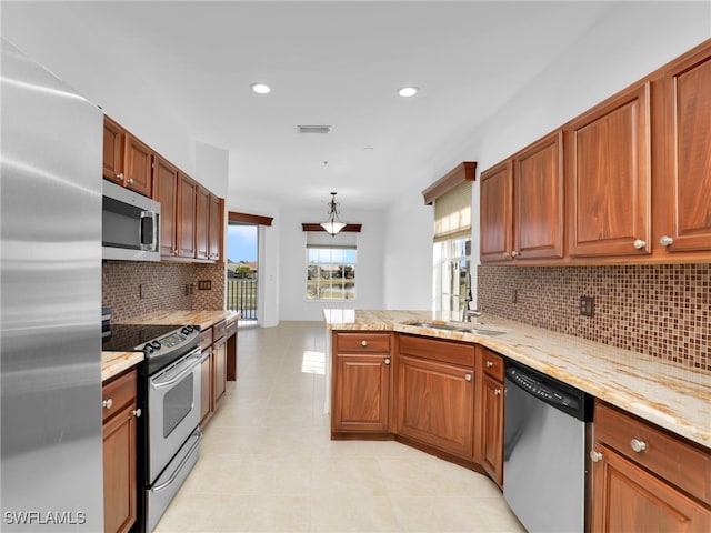 kitchen featuring sink, light tile patterned floors, stainless steel appliances, tasteful backsplash, and kitchen peninsula