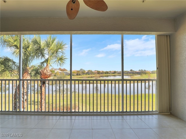 unfurnished sunroom with a healthy amount of sunlight and a water view