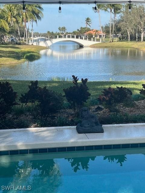 view of swimming pool with a water view