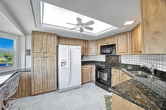 kitchen featuring light tile patterned flooring, sink, dark stone countertops, ceiling fan, and black appliances