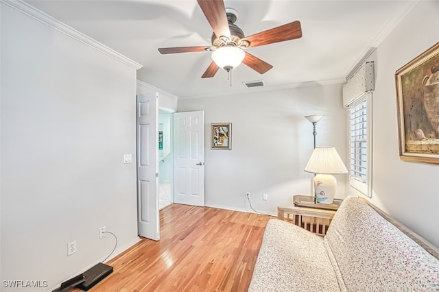 sitting room featuring crown molding, ceiling fan, and hardwood / wood-style flooring