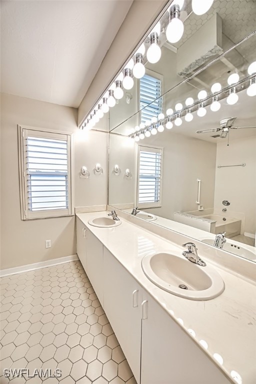 bathroom with ceiling fan, tile patterned floors, and vanity