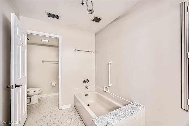 bathroom featuring toilet, a bathing tub, and tile patterned flooring