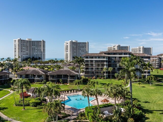 view of pool featuring a lawn and a patio area