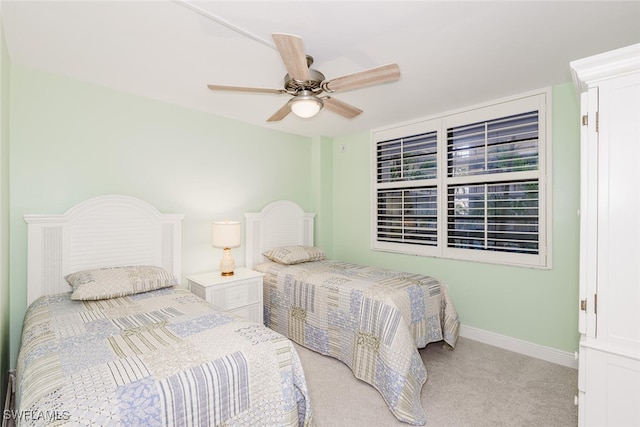 bedroom with ceiling fan and light colored carpet