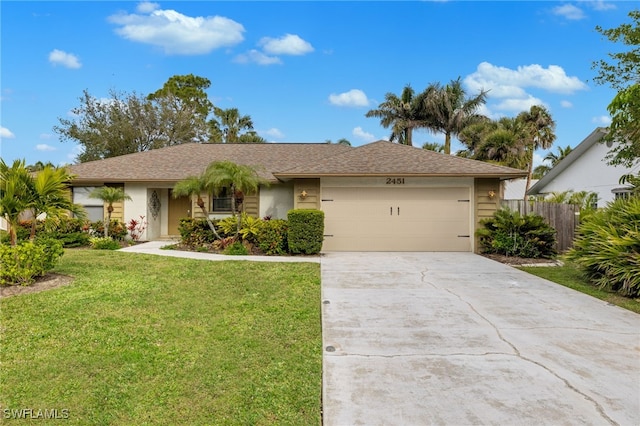 single story home with a garage and a front lawn