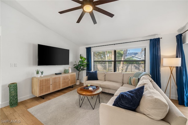 living room featuring hardwood / wood-style flooring, ceiling fan, and lofted ceiling