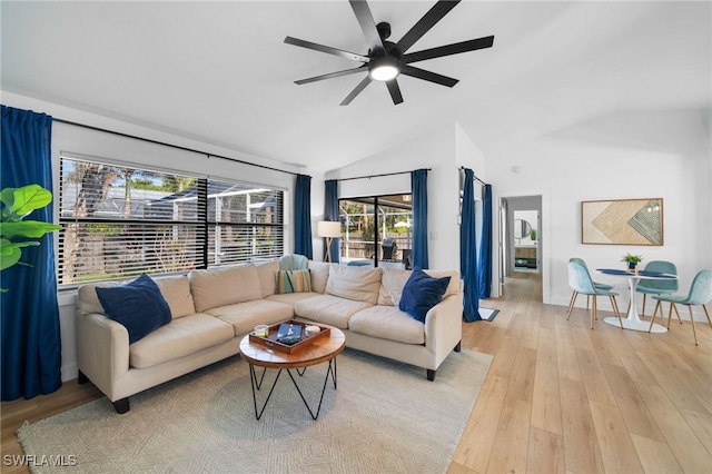 living room with vaulted ceiling, ceiling fan, and light hardwood / wood-style flooring