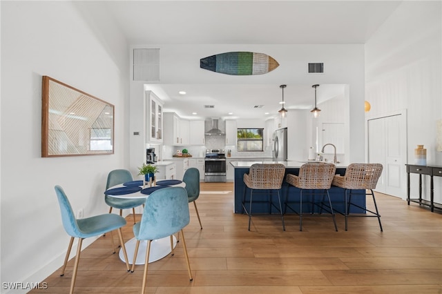 dining room featuring sink and light hardwood / wood-style floors