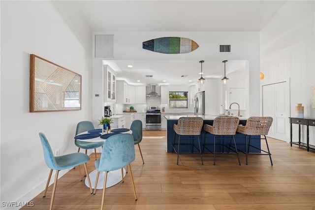 2451 River Reach Dr, Naples, FL 34104 - dining room featuring recessed lighting, baseboards, light wood finished floors, and visible vents