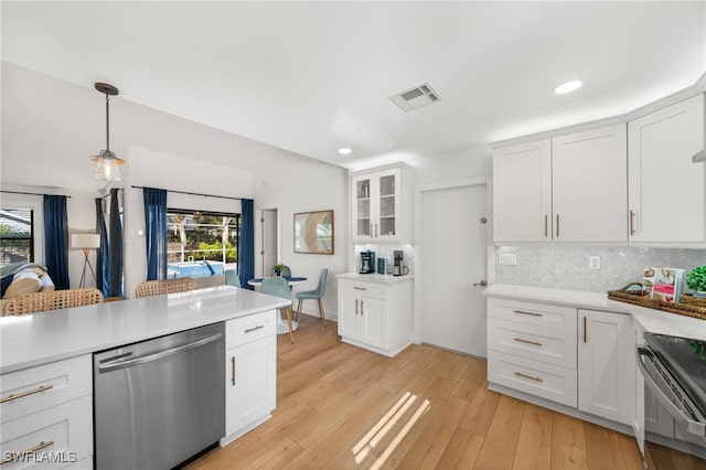 kitchen featuring backsplash, stainless steel appliances, and white cabinets