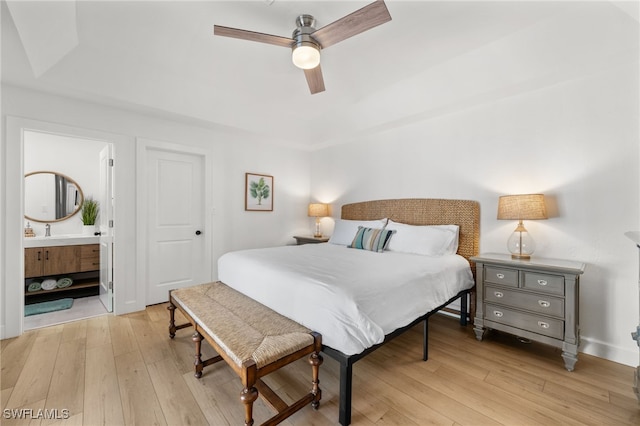 bedroom with light hardwood / wood-style flooring, ceiling fan, and ensuite bathroom