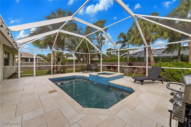 view of swimming pool featuring an in ground hot tub, a lanai, grilling area, and a patio