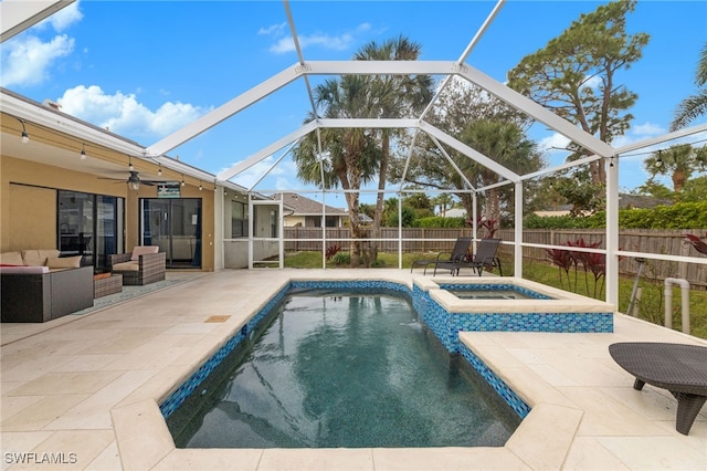 view of pool featuring a patio, an outdoor hangout area, ceiling fan, and glass enclosure