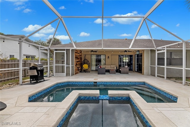 2451 River Reach Dr, Naples, FL 34104 - view of swimming pool with glass enclosure, area for grilling, fence, a patio, and ceiling fan