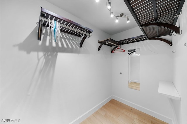 spacious closet featuring hardwood / wood-style floors