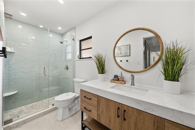 bathroom featuring tile patterned floors, vanity, toilet, and an enclosed shower