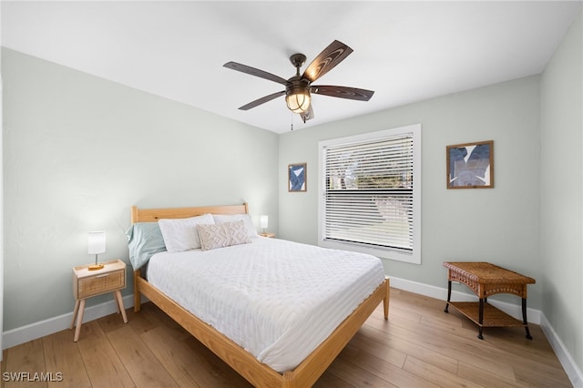 bedroom with wood-type flooring and ceiling fan