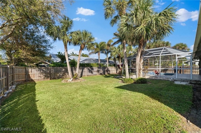 2451 River Reach Dr, Naples, FL 34104 - view of yard with glass enclosure, a fenced in pool, a fenced backyard, and a patio area
