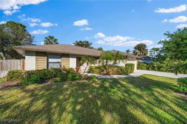 ranch-style house with a garage and a front lawn