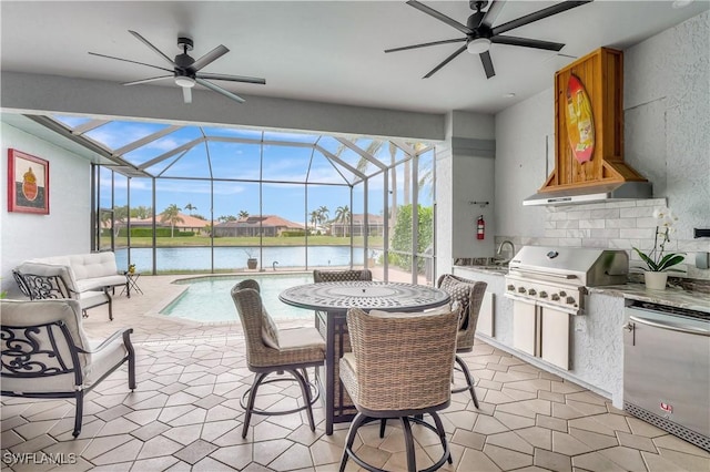 view of patio with an outdoor kitchen, a water view, area for grilling, and an outdoor wet bar