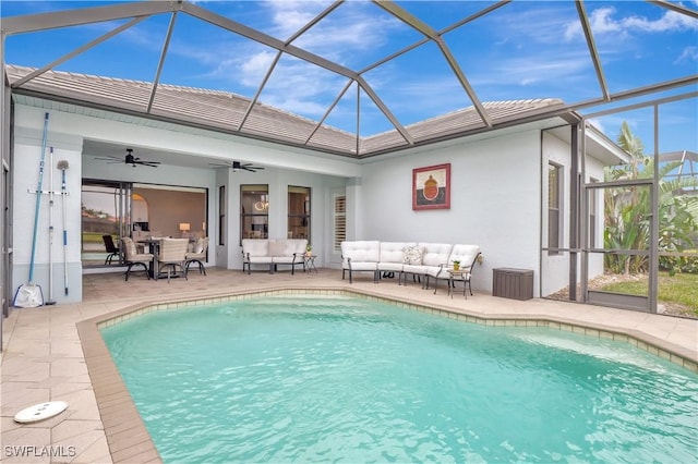 view of pool featuring ceiling fan, glass enclosure, outdoor lounge area, and a patio