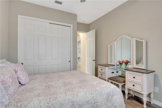 bedroom featuring light wood-type flooring and a closet