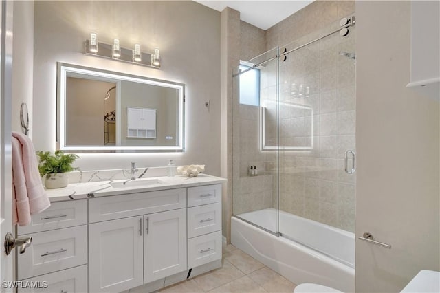 full bathroom featuring tile patterned floors, toilet, shower / bath combination with glass door, and vanity