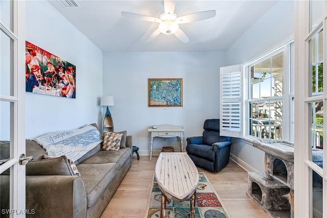 living room with ceiling fan and light wood-type flooring