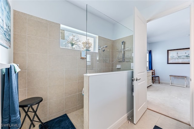 bathroom featuring tiled shower and tile patterned floors