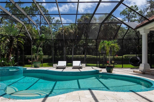 view of swimming pool featuring a lanai and a patio area