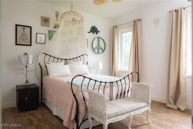 bedroom with wood-type flooring